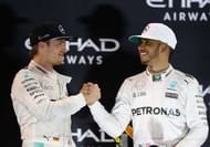 ABU DHABI, UNITED ARAB EMIRATES - NOVEMBER 27:  Race winner Lewis Hamilton of Great Britain and Mercedes GP shakes hands with second place finisher and F1 World Drivers Champion Nico Rosberg of Germany and Mercedes GP on the podium  during the Abu Dhabi Formula One Grand Prix at Yas Marina Circuit on November 27, 2016 in Abu Dhabi, United Arab Emirates.  (Photo by Clive Mason/Getty Images)